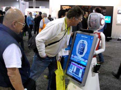 People look at a robot at the Consumer Electronics Show in Las Vegas January 6, 2015