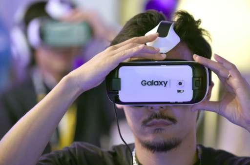 People play with virtual reality head gear &quot;Gear VR&quot; by Oculus during the Tokyo Game Show in Chiba on September 17, 20
