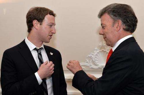 Picture released by the Colombian Presidency press office showing Colombian President Juan Manuel Santos (R) with Facebook found