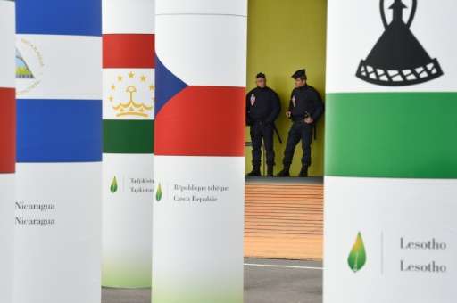 Police officers stand guard at the entrance of the COP21 United Nations Conference on climate change, at Le Bourget, northeaster