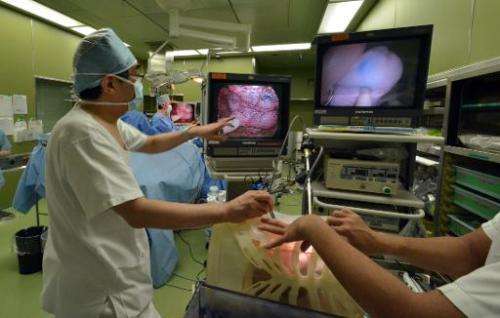 Professor Toshiaki Morikawa (L) gives a lesson while using a 3D-printed lung at the Jikei University hospital in Tokyo