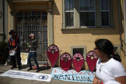 Protesters rally outside a San Francisco apartment building accused of evicting all its tenants to convert units into Airbnb ren