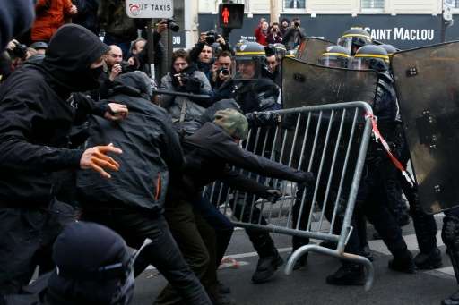 Protestors clash with riot police during a rally against global warming in Paris, a day ahead of the start of the UN conference 