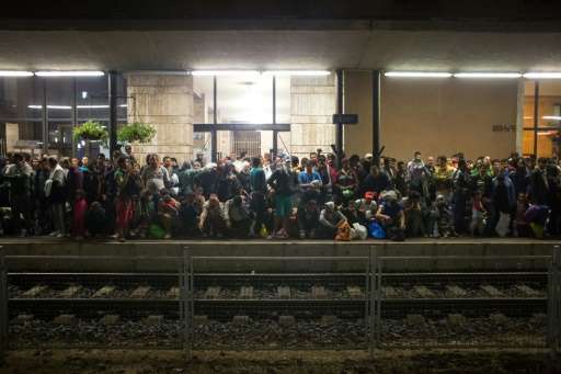 Refugees wait for a train from Gyor to Hegyeshalom in Hungary on September 19, 2015
