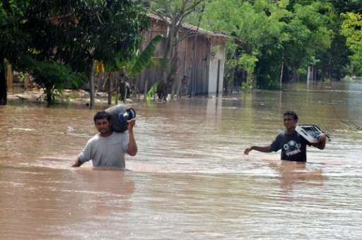 Residents of El Progreso in Honduras leave their flooded homes following Tropical Storm Matthew in 2010
