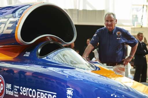 Richard Noble, project director of the Bloodhound Supersonic Car, poses for a photograph alongside the car at Canary Wharf in ea