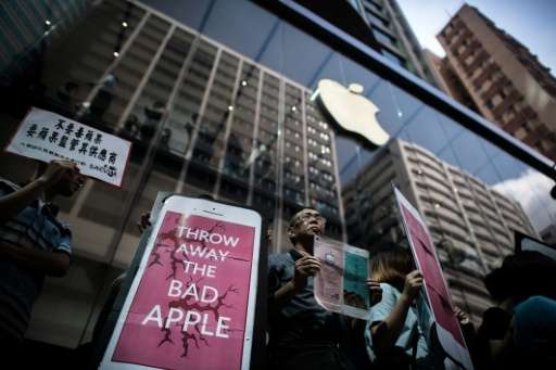 Rights campaigners stage a protest coinciding with the launch of the new iPhone 6s outside an Apple store in Hong Kong on Septem