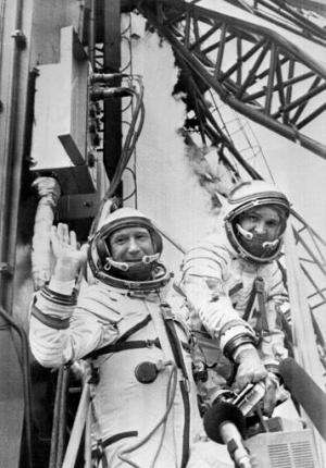 Russian cosmonaut Alexei Leonov (L) and his colleague wave while getting into their spaceship ready to be launched on July 15, 1