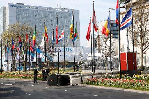 Security guards stand in a street on the opening day of the Global Conference of Cyberspace in The Hague on April 16, 2015