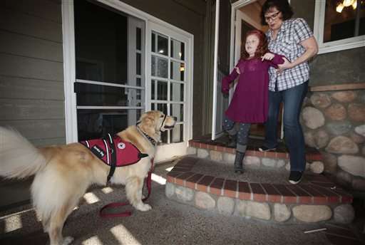 Service dogs that sniff out seizures improve kids' lives