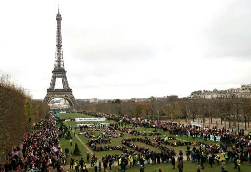Several NGOs gather to form a human chain on the Champs de Mars near the Eiffel Tower on December 12, 2015