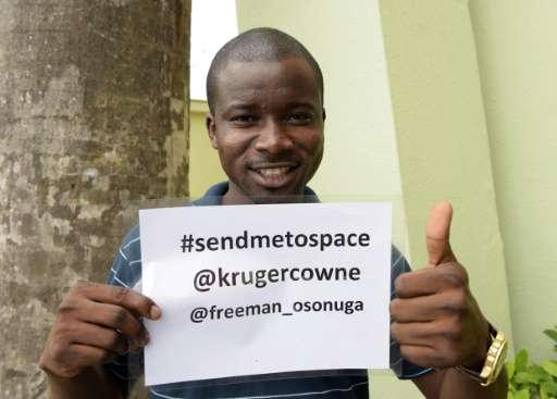 Space enthusiast Freeman Osonuga holds a campaign flyer to solicit support for his quest to be selected to be the first black Af
