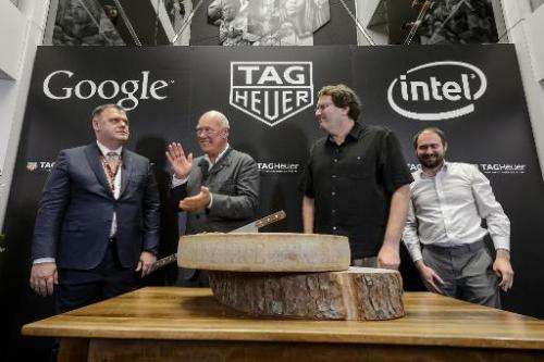 Tag Heuer Director General Guy Semon (L), CEO Jean-Claude Biver, Intel's new device general manager Michael Bell and Google's en