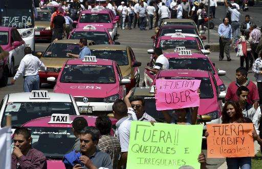 Taxi drivers take part in a protest against the private taxi company Uber for alleged unfair competition, in Mexico City on May 