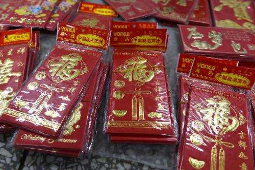 The Chinese tradition of giving gifts of money in red envelopes at Lunar New Year has turned into big business for Web giants Al