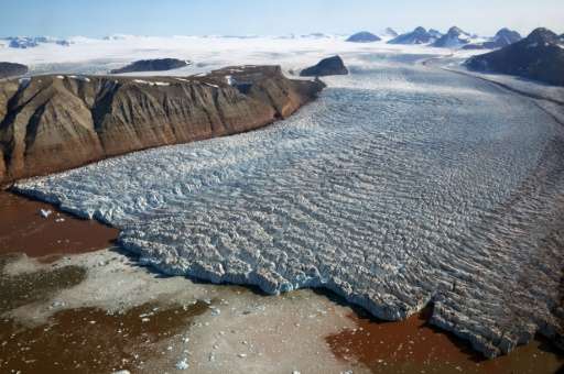 The Kronebreen glacier with red traces of sediments near the scientific base of Ny Alesund