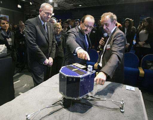 The National Centre for Space Studies (CNES) president Jean-Yves Le Gall (L), French President Francois Hollande and French astr