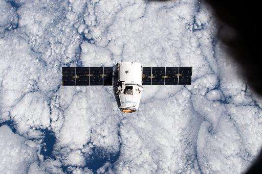 The SpaceX Dragon cargo craft approaches the International Space Station on a mission in January 2015