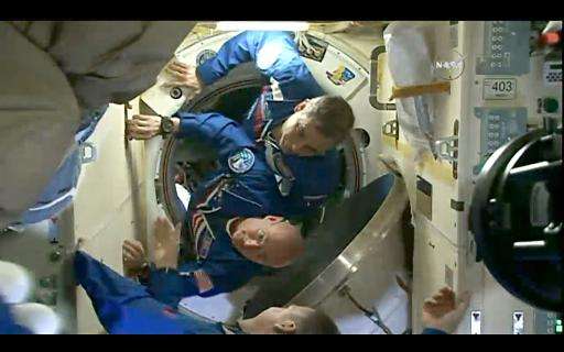 This March 28, 2015 still image from NASA TV shows American astronaut Scott Kelly(bottom) and Russian Mikhail Kornienko(top) ent