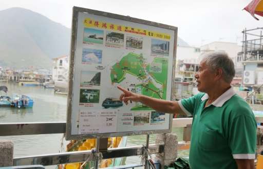 Tour boat operator Wong Yung-kan points out the locations where Hong Kong's famous pink dolphins can be found in the waters arou