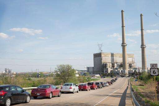 Traffic backs up at an intersecton in front of a power plant in Joliet, Illinois on May 7, 2015