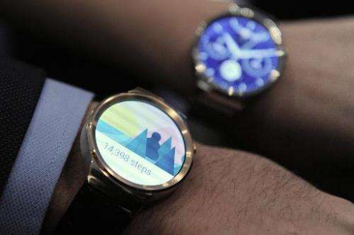 Two models show the new Huawei's device &quot;Huawei Watch&quot; during a press conference in Barcelona, Spain, on March 1, 2015