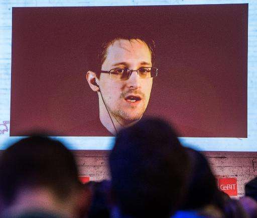 US National Security Agency (NSA) whistleblower Edward Snowden speaks via live video during the CeBIT technology fair in Hanover