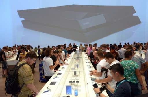 Visitors check out smartphones at the exhibition booth of Sony, during the electronics exhibition IFA, in Berlin, in 2014