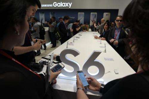 Visitors test Samsung Galaxy S6 smartphones on the opening day of the 2015 Mobile World Congress in Barcelona on March 2, 2015