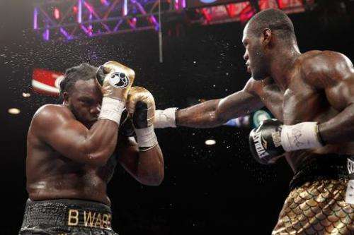 WBC heavyweight champion Bermane Stiverne (L) takes a punch from Deontay Wilder during their title fight at the MGM Grand Garden