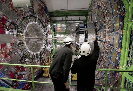 Workers check equipment at CERN in February, 2015