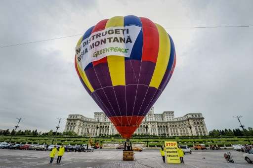 Activists stand next to a hot air balloon with a banner reading &quot;Do not destroy Rosia Montana&quot;, to protest against the