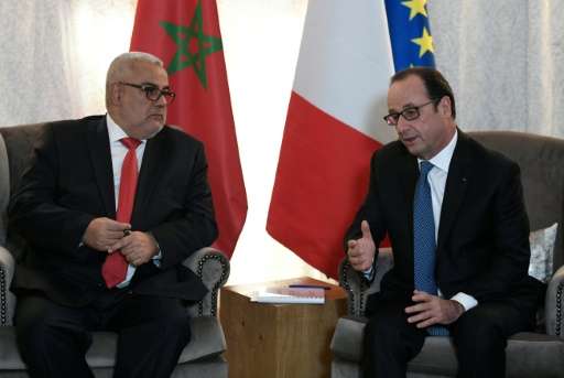 French President Francois Hollande (R) meets Moroccan Prime Minister Abdelilah Benkirane on the sidelines of the COP22 Climate C