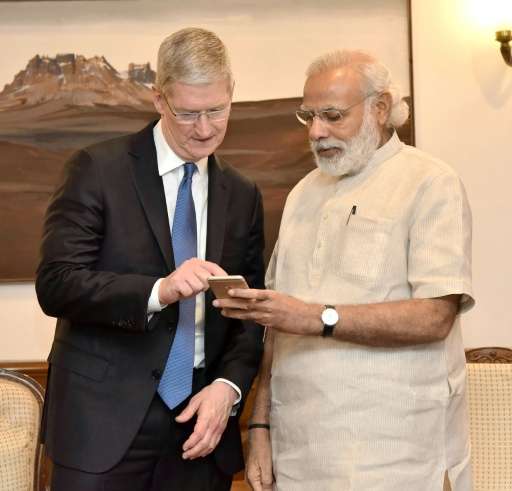 Indian Prime Minister Narendra Modi speaks with Apple CEO Tim Cook during a meeting in New Delhi on May 21, 2016
