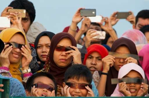 People watch the total solar eclipse in Banda Aceh on March 9, 2016