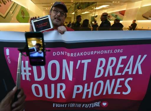 Protesters demonstrate outside an Apple Store as they object to the US Government's attempt to put a backdoor to hack into the A