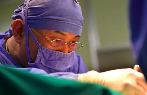 South Korean scientist Hwang Woo-Suk performs an embryo-injection operation on a surrogate mother dog at Sooam Biotech