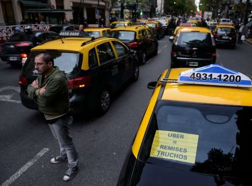 Taxi drivers block Mayo avenue during a protest against Uber in Buenos Aires on April 12, 2016