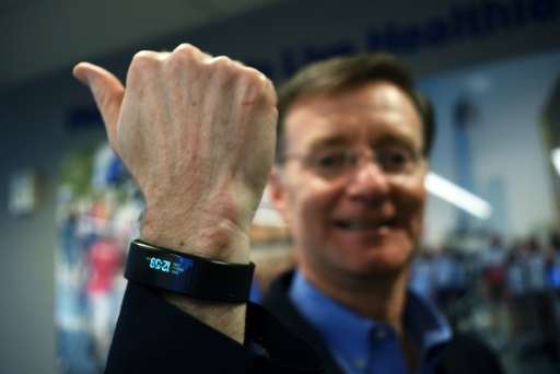 United Healthcare New York CEO Michael McGuire poses wearing a special activity tracker at his office in New York on March 24, 2