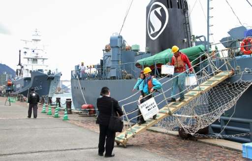 Workers disembark from a whaling ship at the port of Shimonoseki in western Japan, on March 24, 2016
