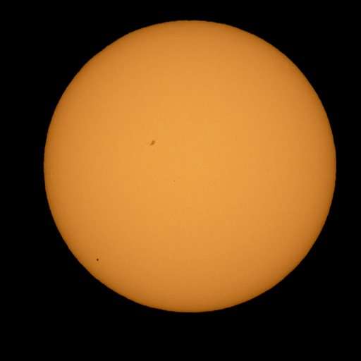Little Mercury a black dot as it crosses vast face of sun