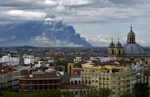 A huge smoke column caused by a fire at a tyre dump near the town of Sesena pictured from the Almudena cathedral in Madrid on Ma