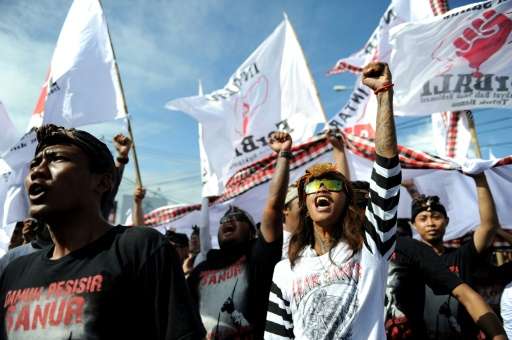 Local residents shout slogans during a demonstration in Sanur, on Indonesia's resort island of Bali, on July 17, 2016