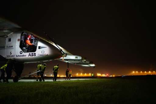 Solar Impulse 2 workers tow the experimental solar-powered aircraft to the runway in Tulsa, Oklahoma, on May 21, 2016