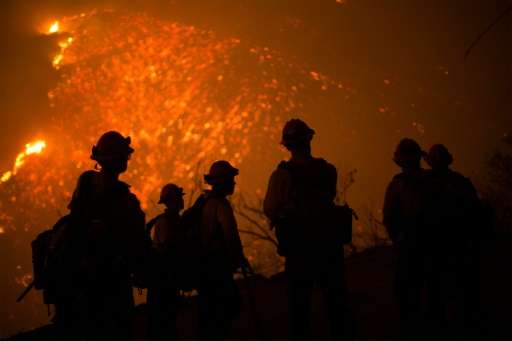 Firefighters battle an expanding wildfire, the Sherpa Fire, near Santa Barbara, California on June 17, 2016