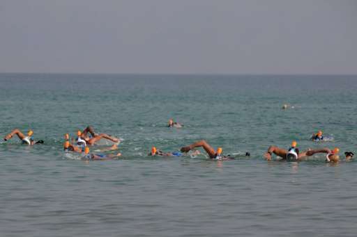 Participants take part in a 17-kilometre swim from Jordan to Israel across the Dead Sea, organised by the EcoPeace charity aimed