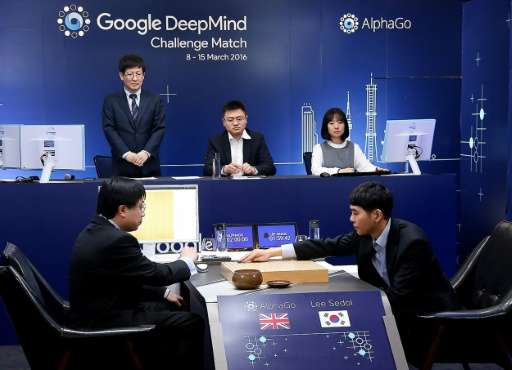South Korean Go grandmaster Lee Se-Dol (R) makes a move during the first in a five-game series against AlphaGo in Seoul on March
