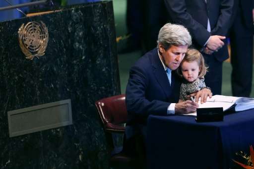 US Secretary of State John Kerry holds his granddaughter at the UN Signing Ceremony for the Paris climate accord in April