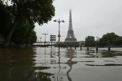 A picture taken on June 2, 2016 shows the river Seine bursting its banks next to the Eiffel Tower in Paris