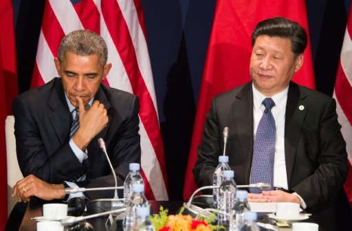 US President Barack Obama (L) sits with Chinese President Xi Jinping during a bilateral meeting ahead of the opening of the UN c